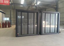Modular container home exterior with wooden facade accents