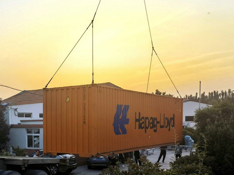 Shipping container with NAVISOUL boats from outside